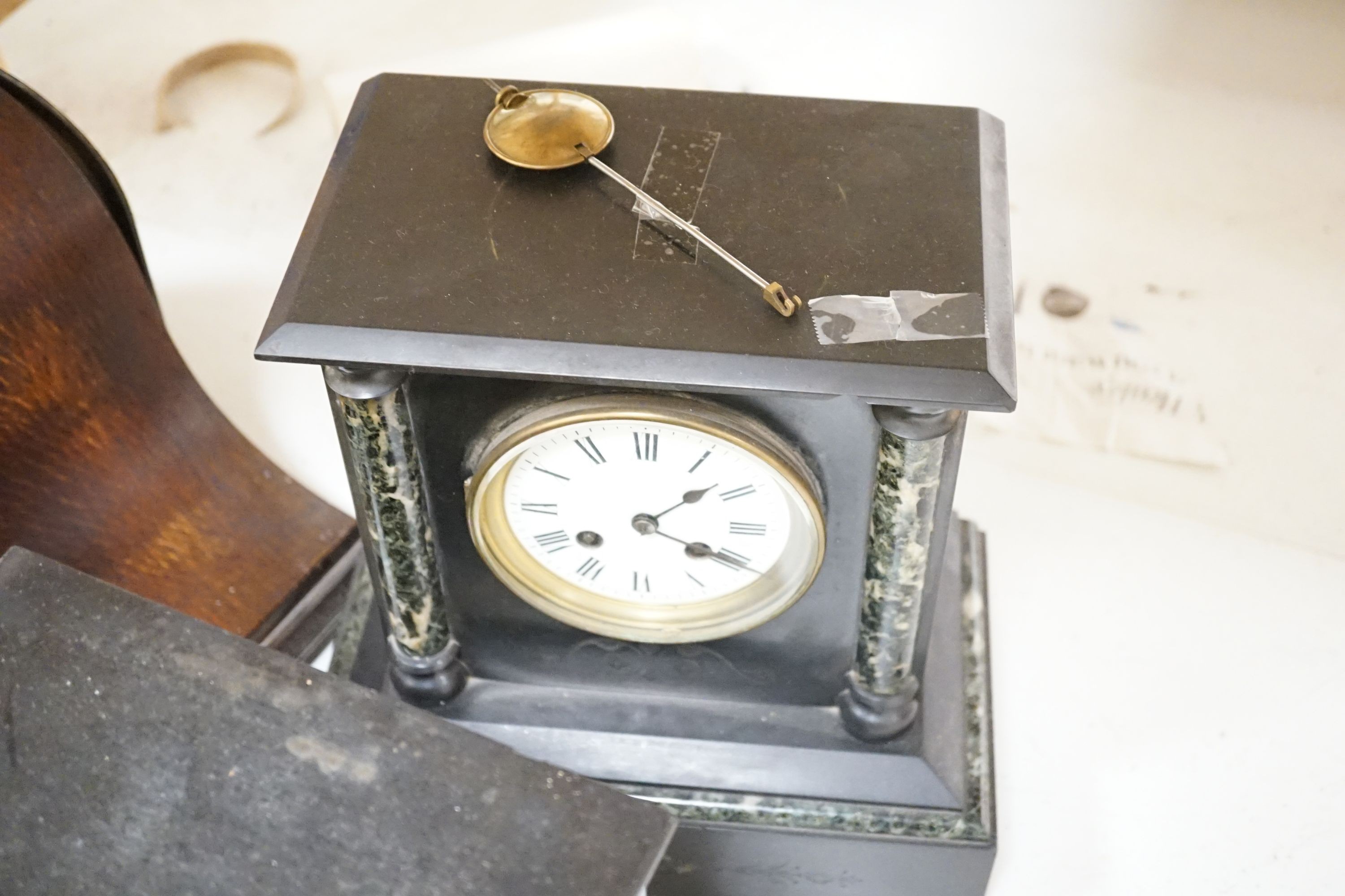 Two 19th century slate mantel clocks, three Edwardian and later wooden mantel clocks and a barometer, tallest 31 cms high.